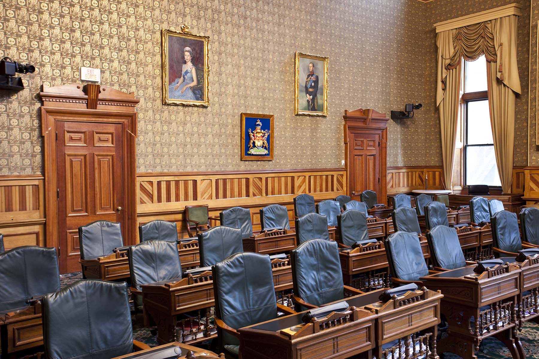 Photo de la Chambre de l’Assemblée législative montrant des rangées de fauteuils et de pupitres pour les parlementaires